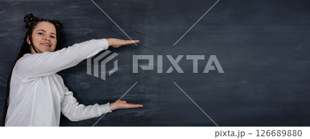 A Woman is Presenting on a Chalkboard Background Designed for Various Educational Content 126689880