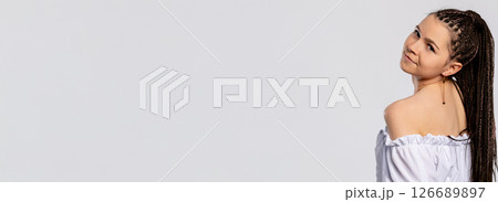 A Stylish Young Woman with Beautifully Braided Hair and a confident, cheerful demeanor 126689897