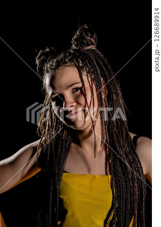 A Fashionable Model with a Unique and Striking Hairstyle Posing in Studio Lighting for a Shoot A Fashionable Model with a Unique and Striking Hairstyle Posing in Studio Lighting for a Shoot 126689914