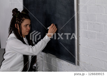 A dedicated teacher inspires students by sharing important information in a vibrant classroom 126689915