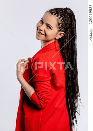 A Confident Young Woman Sporting Braids, Dressed in a Vibrant and Stylish Red Outfit 126689928
