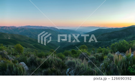 A serene valley unfolds from a mountaintop at dawn; mist weaves through trees as the world awakens. A serene valley unfolds from a mountaintop at dawn; mist weaves through trees as the world awakens. 126690392