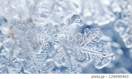 A close-up of a snowflake reveals its intricate, delicate patterns, showcasing nature's unique artistry. 126690463