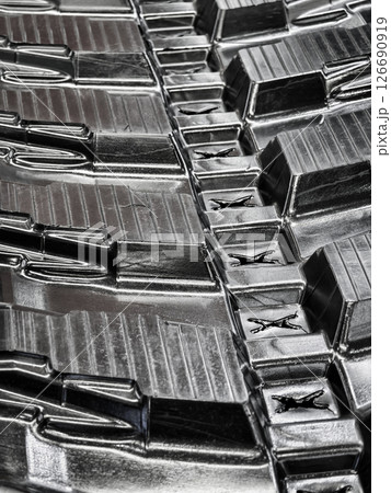 Close-up view of a textured tire tread showcasing intricate patterns and grooves in detail 126690919