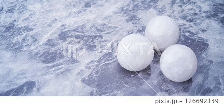 White spheres on a textured gray surface 126692139