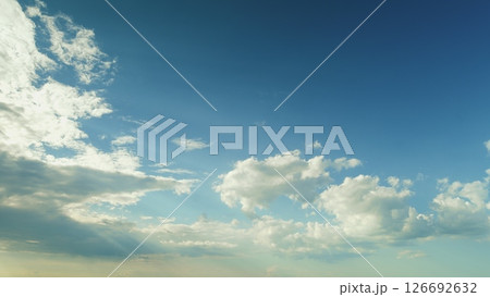 A beautiful blue sky adorned with fluffy clouds creates a picturesque outdoor scene Time lapse. 126692632