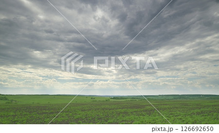 A Serene Landscape Featuring Stunning and Dramatic Cloudy Skies That Captivate the Eye Time lapse. 126692650