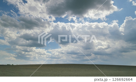 An Expansive, Cloudy Sky Over a Beautifully Serene and Picturesque Landscape Scene Time lapse. An Expansive, Cloudy Sky Over a Beautifully Serene and Picturesque Landscape Scene Time lapse. 126692664
