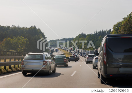 Back tail view of many cars stuck in row at highway road traffic jam cold overcast rainy winter day at Europe. Automobile accident vehicle rush hour collapse. Transportation vacation seasonal stuck Back tail view of many cars stuck in row at highway road traffic jam cold overcast rainy winter day at Europe. Automobile accident vehicle rush hour collapse. Transportation vacation seasonal stuck 126692666