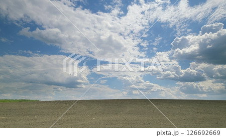 A Stunning Scenic Sky Featuring Dramatic Clouds Stretching Over a Vast Flat Landscape Time lapse. A Stunning Scenic Sky Featuring Dramatic Clouds Stretching Over a Vast Flat Landscape Time lapse. 126692669