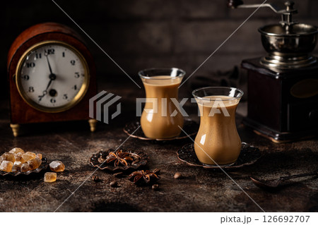 Tea or Coffee with milk and spices Tea or Coffee with milk and spices 126692707
