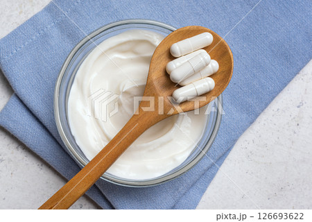 Capsules probiotic and bowl of yogurt 126693622