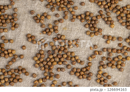 chickpeas on the tablecloth, fried but not boiled chickpeas are on the table with a linen tablecloth chickpeas on the tablecloth, fried but not boiled chickpeas are on the table with a linen tablecloth 126694163