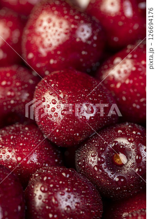 ripe red cherry berries in drops of water, wet red cherry fruits on the kitchen table 126694176