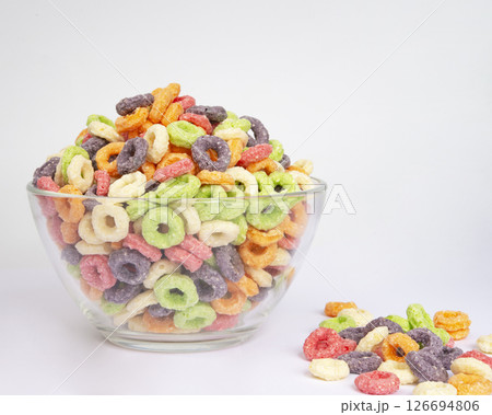 Bowl of colorful crispy corn rings on white background. Breakfast cereal 126694806