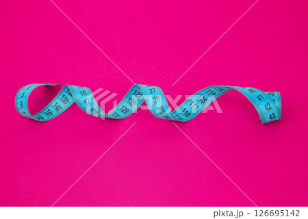 Colored spiral centimeter tape on background with copyspace 126695142