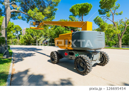 Mobile Boom Lift Platform in City Park on Sunny Day 126695454