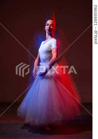 Caucasian woman dancing classical dance in tutu . Long exposure photo.  126695962