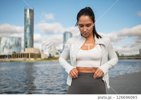 Sporty Woman Stretching Outdoors by the City Waterfront at Sunrise Sporty Woman Stretching Outdoors by the City Waterfront at Sunrise 126696065