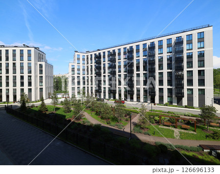 A Modern Residential Complex Featuring Lush Green Surroundings and Scenic City Views 126696133