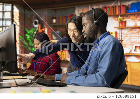 Asian call center senior manager providing guidance to multiethnic team, addressing questions. Customer support workplace onboarding specialist conducts orientation sessions for multiracial coworkers Asian call center senior manager providing guidance to multiethnic team, addressing questions. Customer support workplace onboarding specialist conducts orientation sessions for multiracial coworkers 126699151