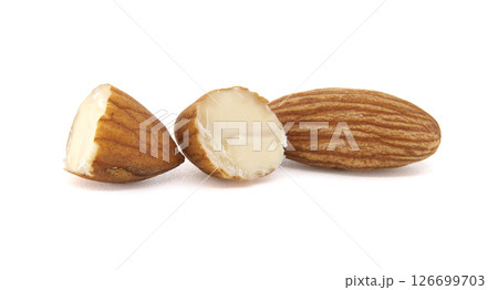 Three almonds, one whole and two broken, arranged on a clean, bright white backdrop. 126699703