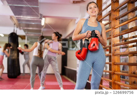 Woman athlete with boxing gloves pose before training in gym 126699756