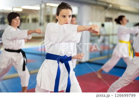 Women in self-defense training in white kimono with belts 126699799