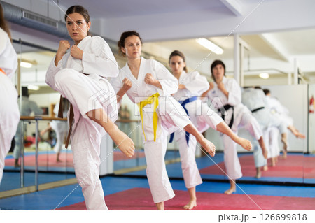 Female athletes standing in formation, kata starting position Female athletes standing in formation, kata starting position 126699818