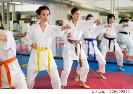 Group of womens practicing martial arts in gym. Active lifestyle and self defense concept 126699850