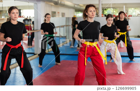 Group of women training karate techniques in studio Group of women training karate techniques in studio 126699905