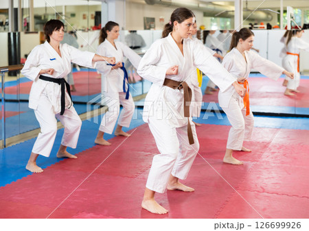 Women in a white kimono in training on a map Women in a white kimono in training on a map 126699926