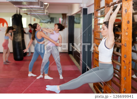 Woman Raising Her Legs While Holding A Wooden Noob Ladder 126699941