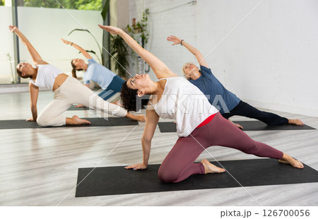Group of women practicing yoga training - pose bhujangasana 126700056