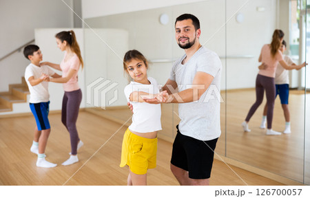 Dad and young daughter learning to dance waltz together 126700057