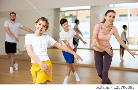 Girl exercising during family dance class 126700085
