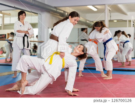 Women practicing a body punch in training 126700126