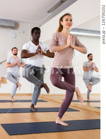 People exercising asana in gym 126700202