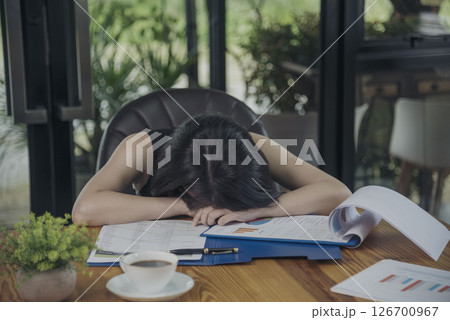 Desperate Asian woman stress headache depressed from startup small business at home office. Failure business woman work at home office. Online seller entrepreneur has problem delivery unhappy job 126700967