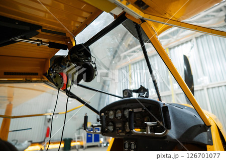 Inside View of a Yellow Aircraft Cockpit with Headsets. Inside View of a Yellow Aircraft Cockpit with Headsets. 126701077