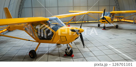 Yellow airplane glider in the hangar. Yellow airplane glider in the hangar. 126701101