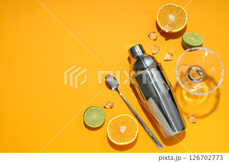 Metal shaker with fresh lime and orange Metal shaker with fresh lime and orange 126702773