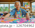 Experienced artist working on a colorful abstract painting in a bright studio setting 126704962