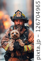 Firefighter rescues a small dog from a dangerous situation in a city setting 126704965