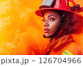 Young female firefighter using a hose in a training drill 126704966