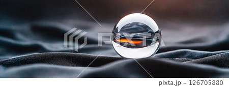 Ethereal figure inside crystal ball on a black velvet cloth creates a mystical atmosphere 126705880