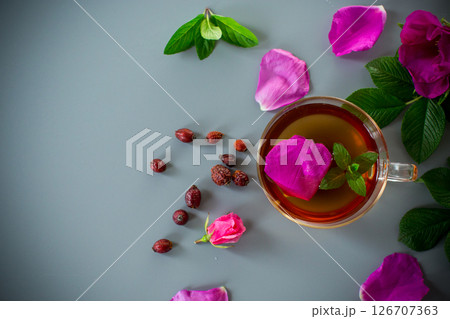Homemade rosehip and mint tea in a transparent cup and teapot Homemade rosehip and mint tea in a transparent cup and teapot 126707363