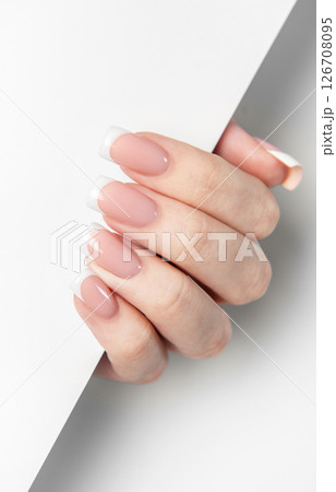 Woman hand showing french manicure on white background 126708095