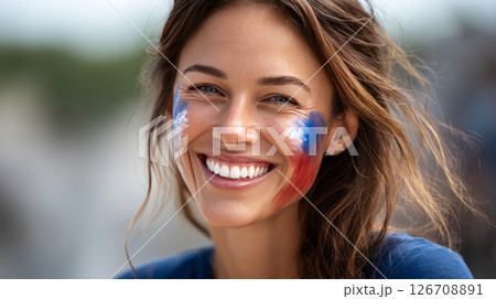 Happy smiling woman with face painted in American flag colors. Election Day in the USA. America Day. Festive Mood on President's Day 126708891
