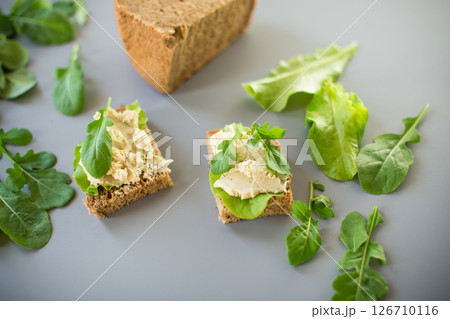 Isolated sandwich with rye bread and herring on the background Isolated sandwich with rye bread and herring on the background 126710116